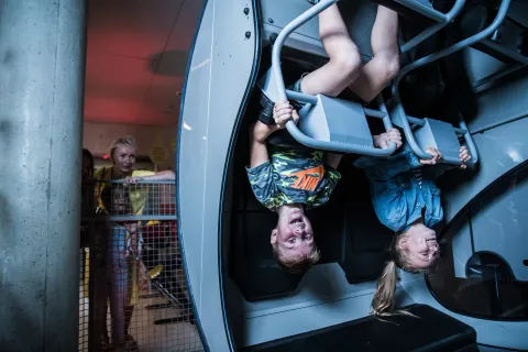 Children hanging upside down on play bars