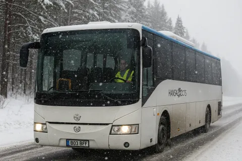 Coach bus driving through heavy snowfall