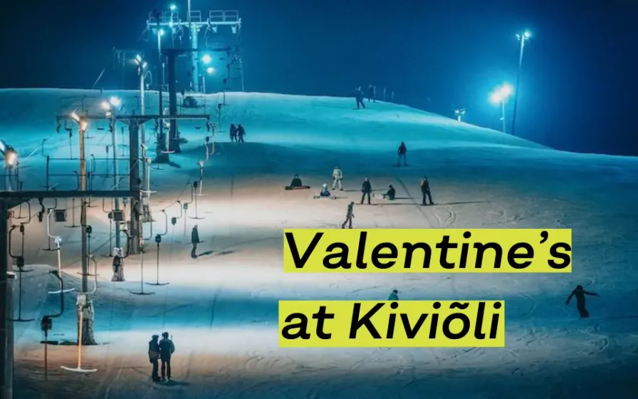 Floodlit ski slope with skiers at night